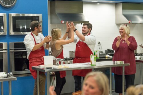 Colorado State University students (Red team: Daniel Davila (glasses), Matt Nelson (no hat) and Sarah Otto; Black team: Mackenzie Burgess (black blouse), Alyssa Rosenblum (pink blouse) and Paul Fritter) compete in a cooking competition hosted by Food Network star Nancy Fuller and The Cooking Studio. September 25, 2018