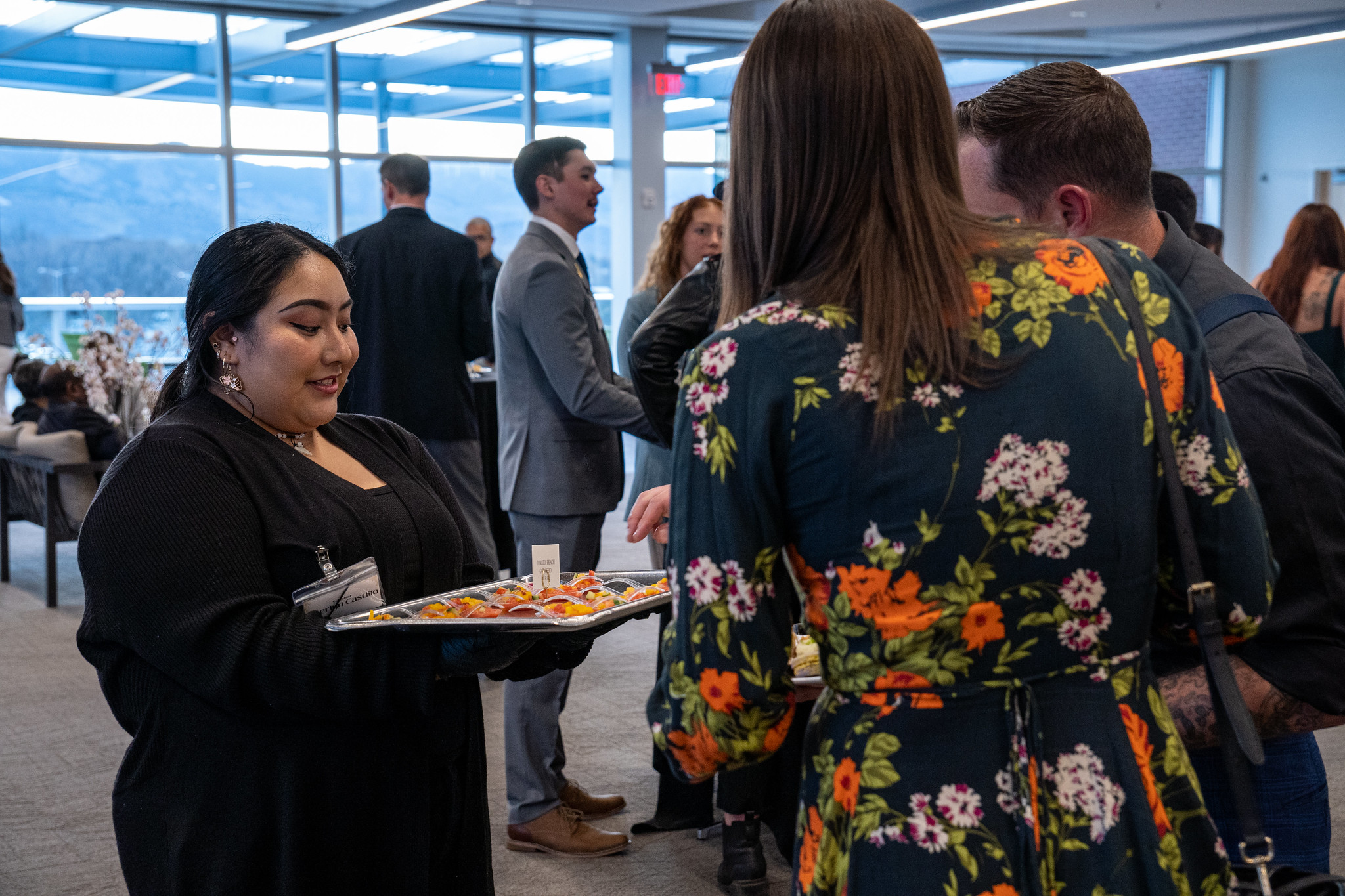 A student holding a tray of appetizers at an event