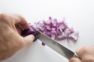 Red onion being chopped