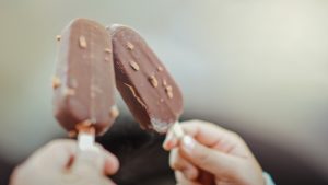 Two chocolate covered ice cream bars