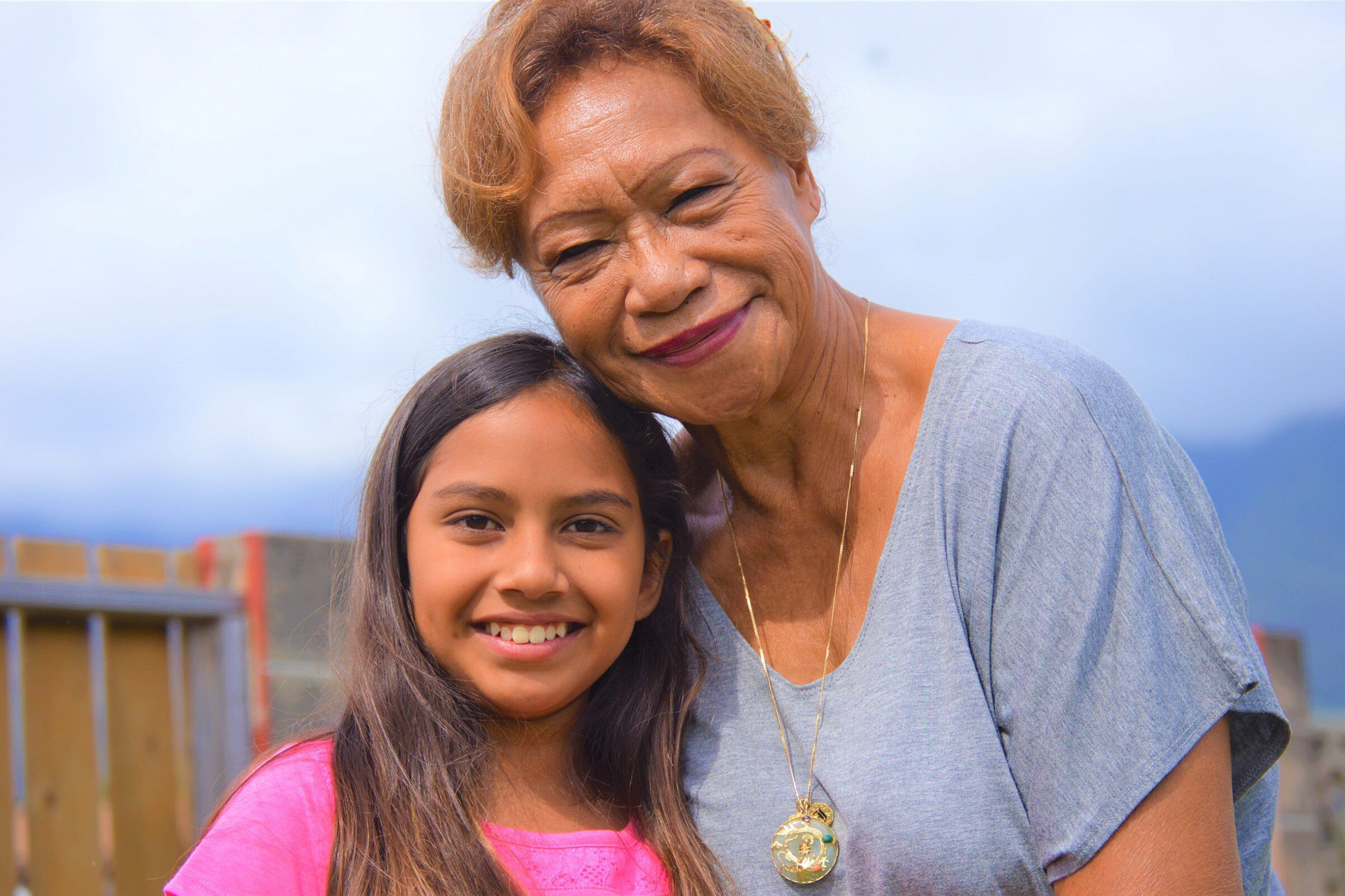 Grandparent and grandchild pose for a photograph