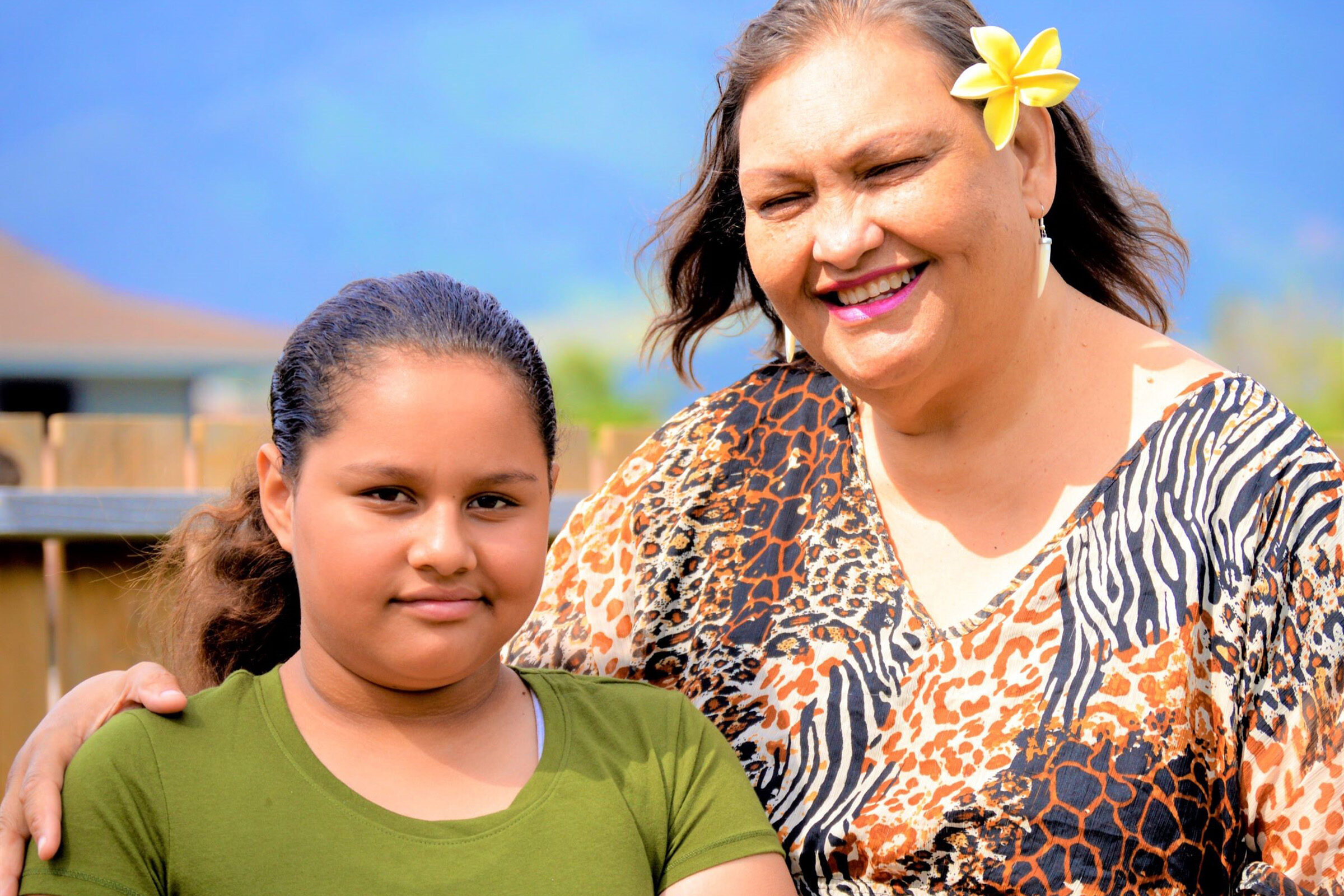 Grandparent and grandchild pose for a photograph