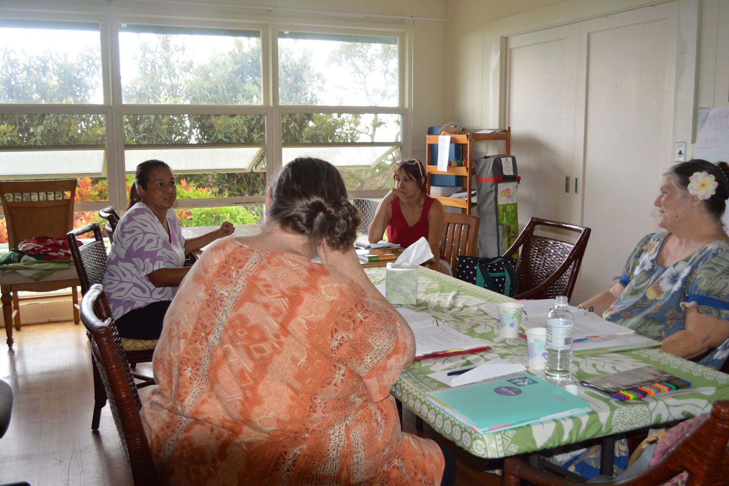 Adults sitting at a table discussing