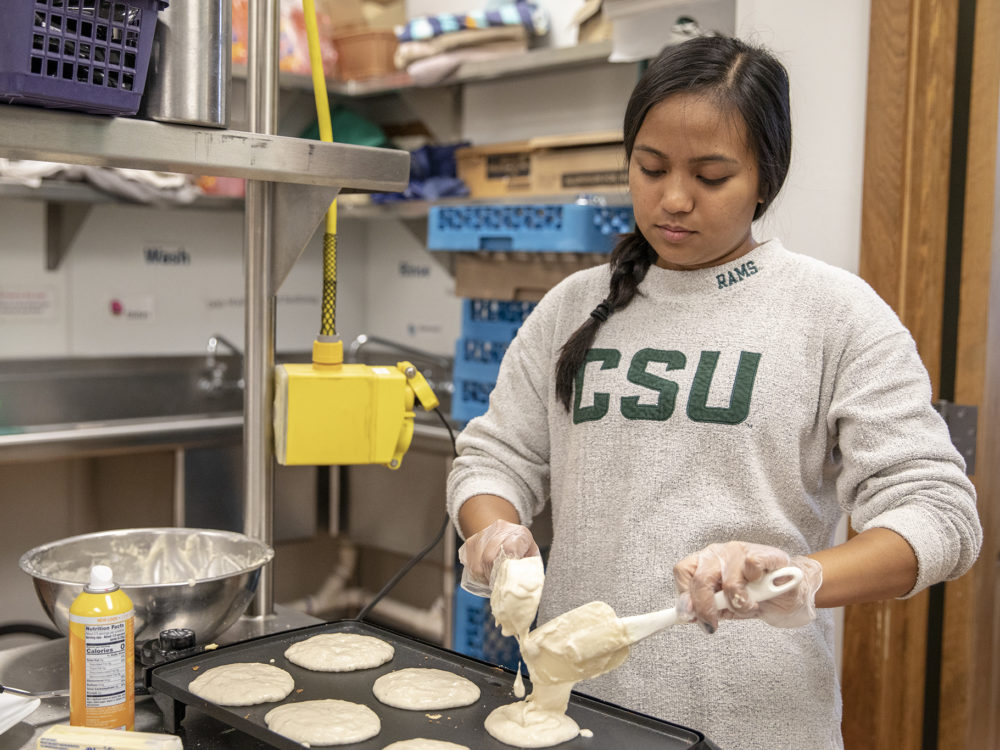 A SOUL student prepares pancakes at the Early Childhood Center.