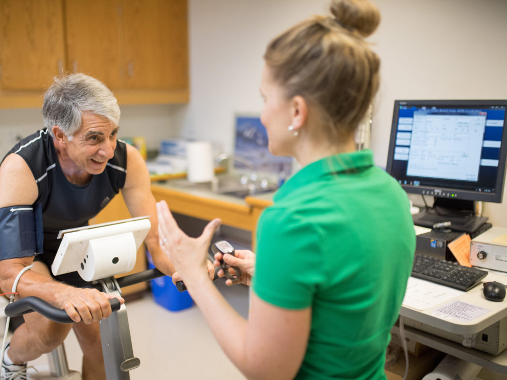 Researcher performing stress test on a man.