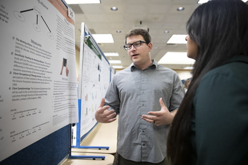 Student talks about research on CHHS Research Day.