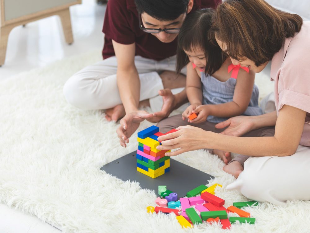 Child and parents playing with blocks