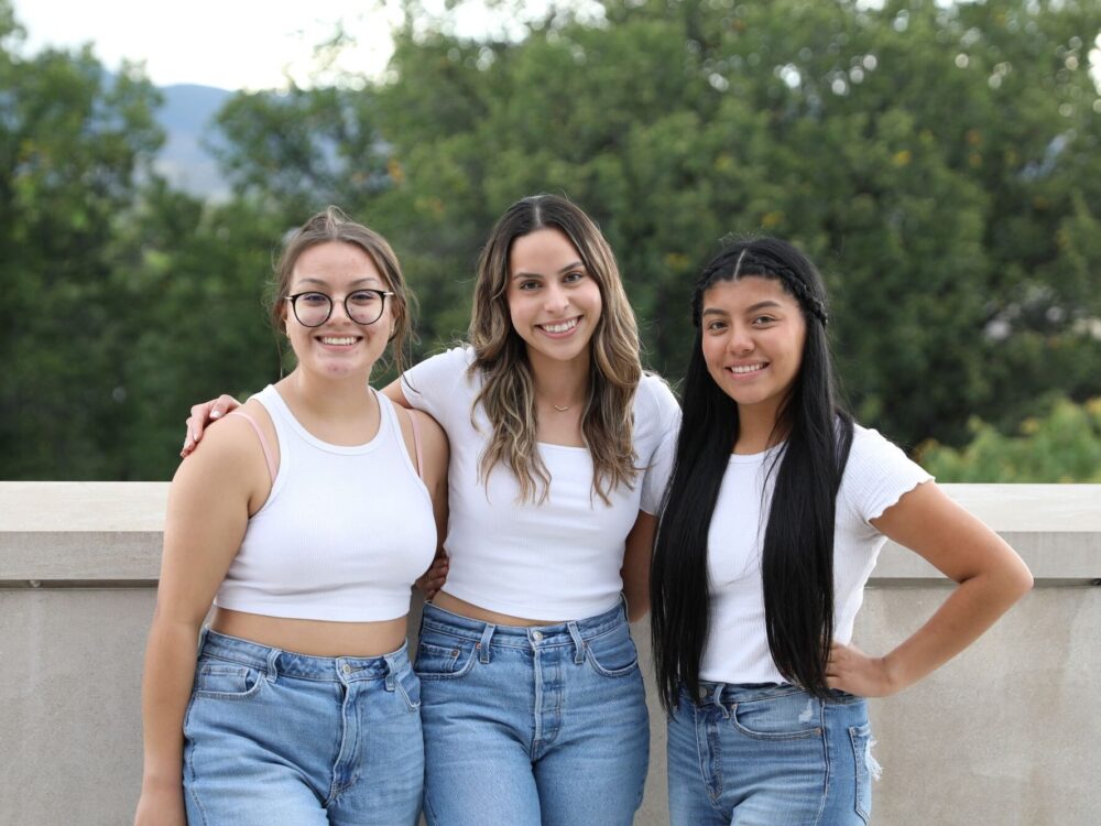 Three women matching in jeans with white tshirts