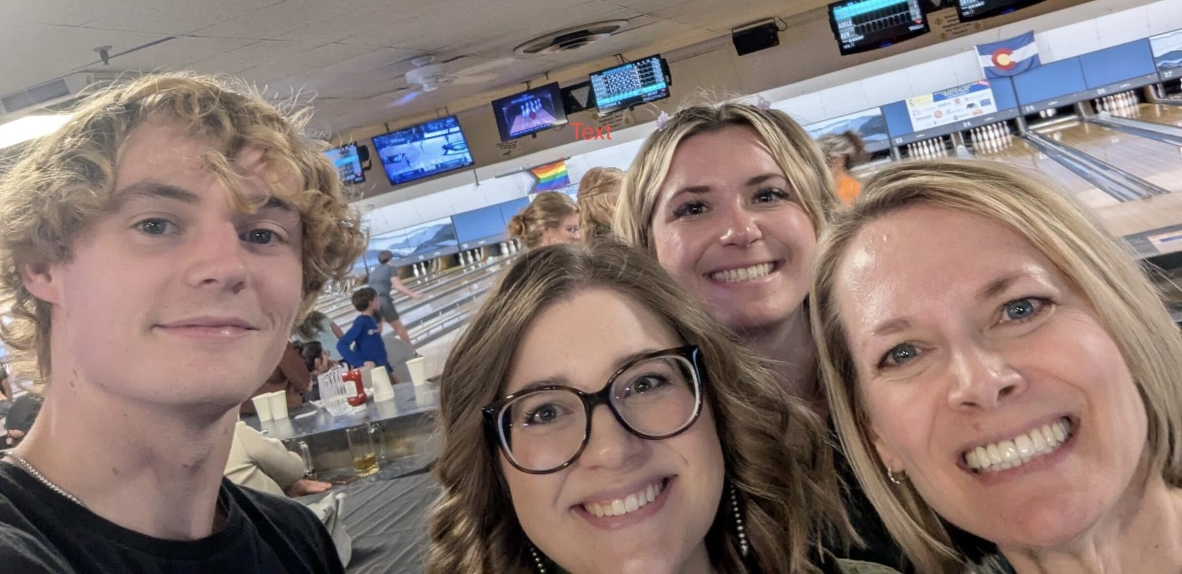 A photo of four Developmental Disabilities Research Lab team members smiling at a bowling alley.