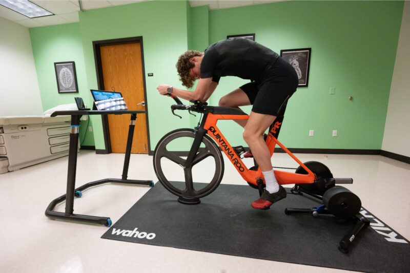 A person rides a stationary bike that is connected to a computer while testing their lactate threshold.