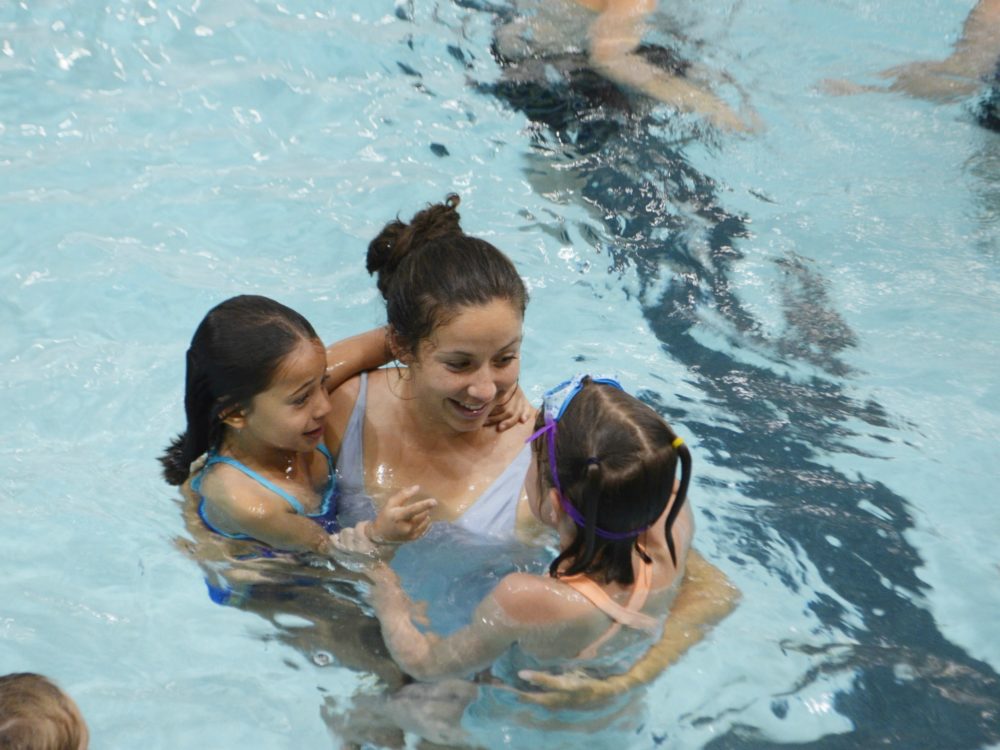 Youth Sport Camps counselor swimming with children