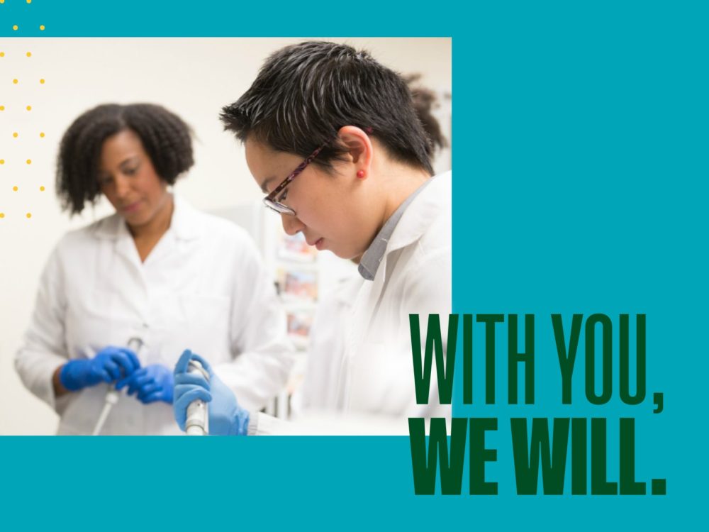 Students in a lab with text `With You, We Will.`
