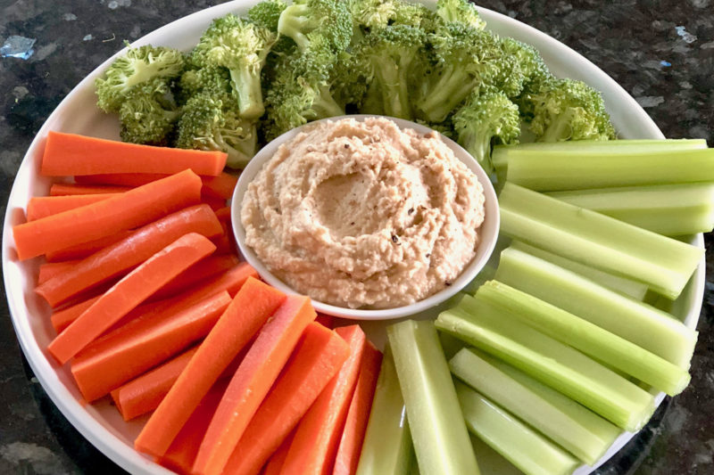 fresh hummus with carrots, celery, and broccoli