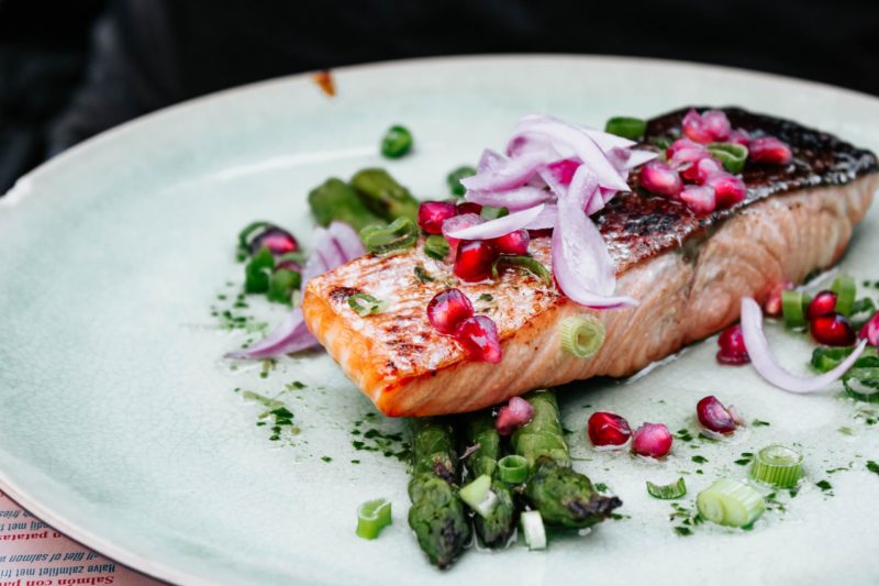 Salmon with red onions, asparagus, and pomegranate seeds