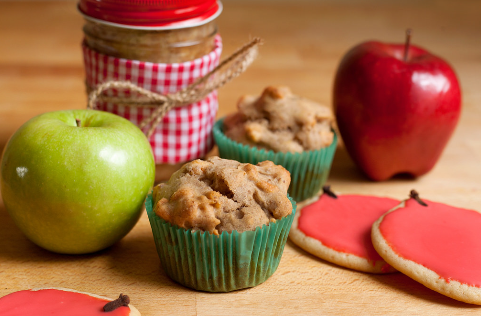 apple spice muffins with fresh red and green apples, jar of preserves