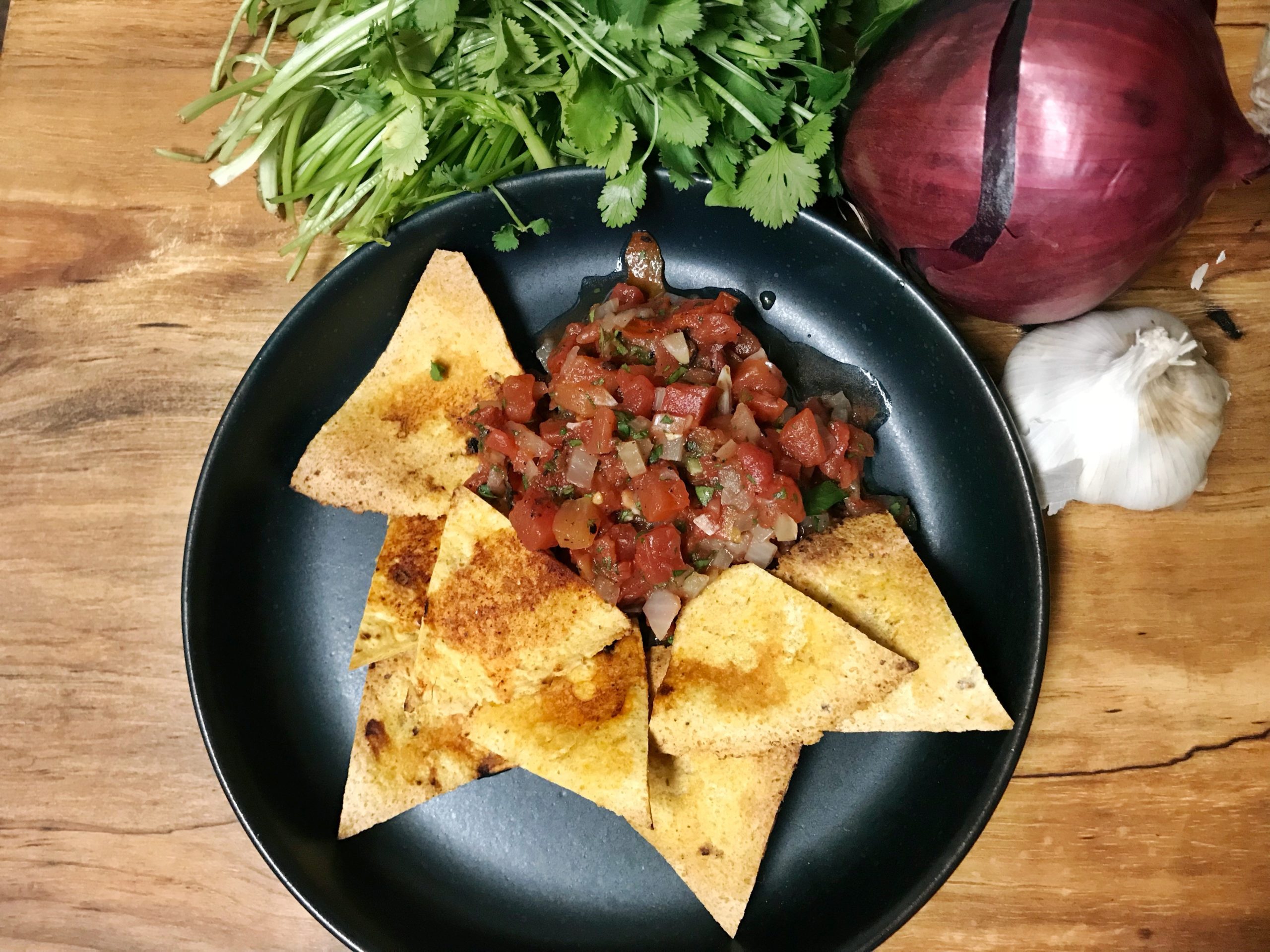 homemade salsa with tortilla chips on a plate