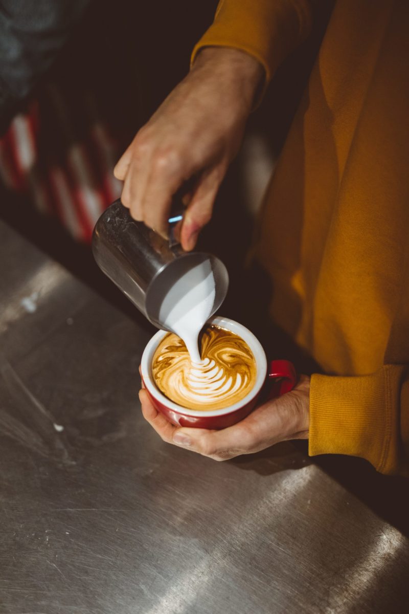 Pouring milk into coffee