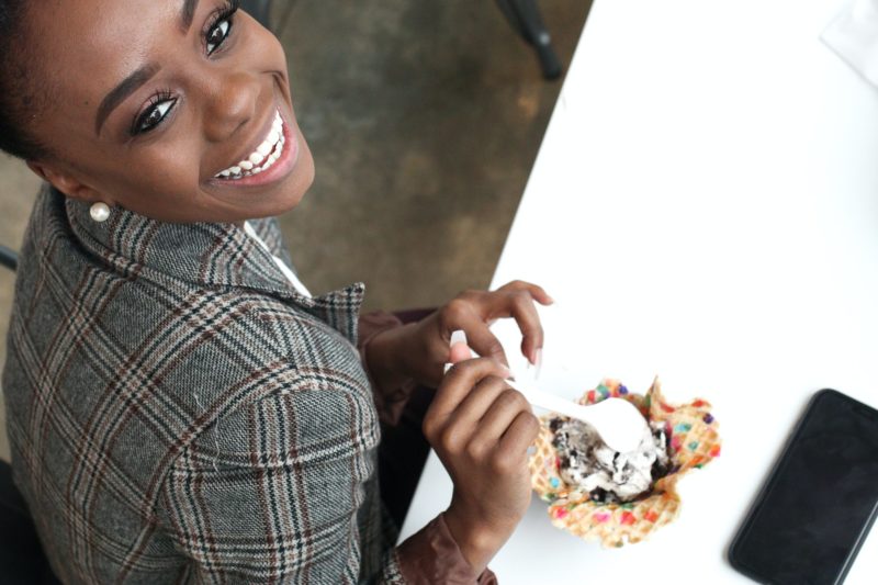 Smiling woman eating ice cream