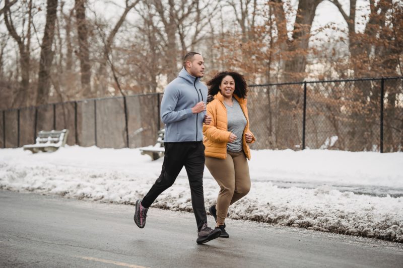 Man and woman running in winter