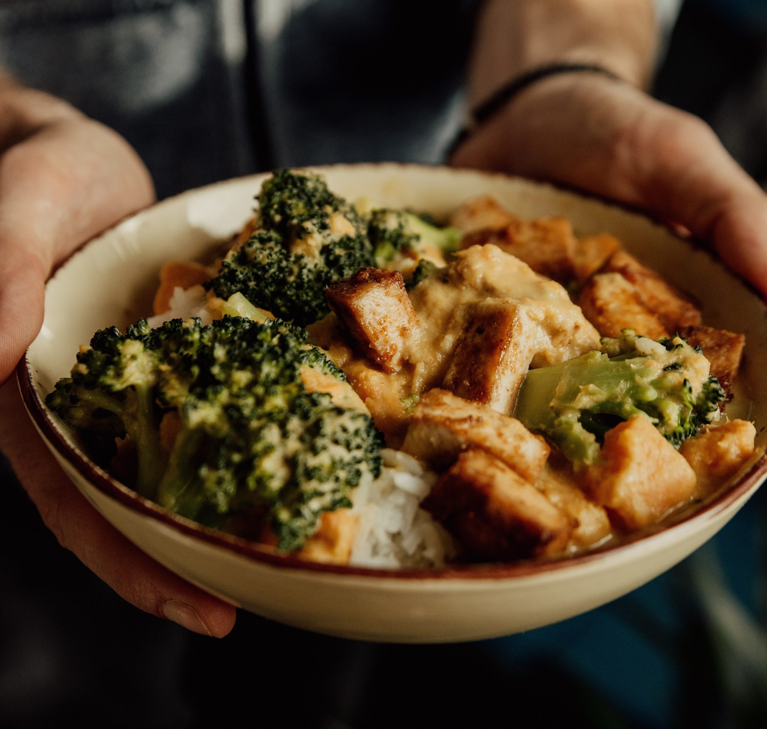Curry tofu with rice and broccoli in bowl