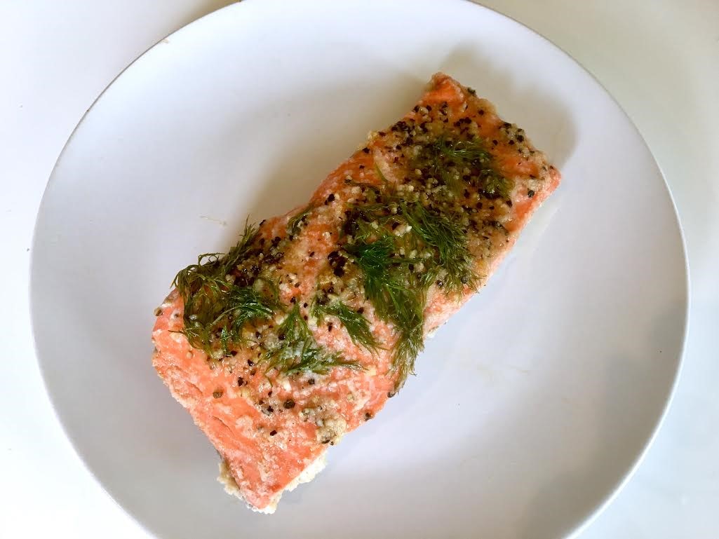 Salmon fillet on a plate with dill and seasonings