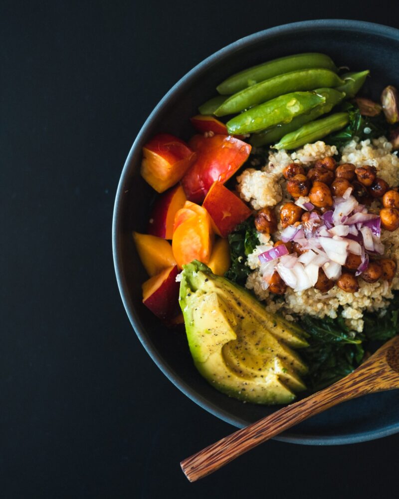 protein bowl with avocado, chickpeas, snap peas, quinoa and nectarine