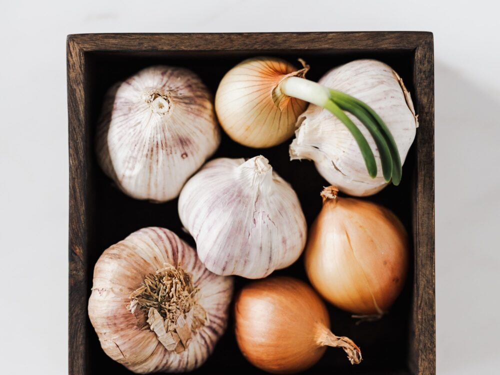 Whole onions and garlic in box