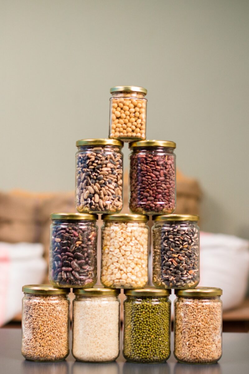various seeds and legumes in jars- stacked into a pyramid