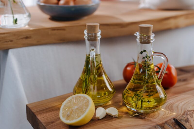 Jars of oil with herbs inside