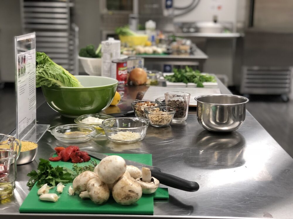 vegetables and ingredients set on a metal prep table for cooking