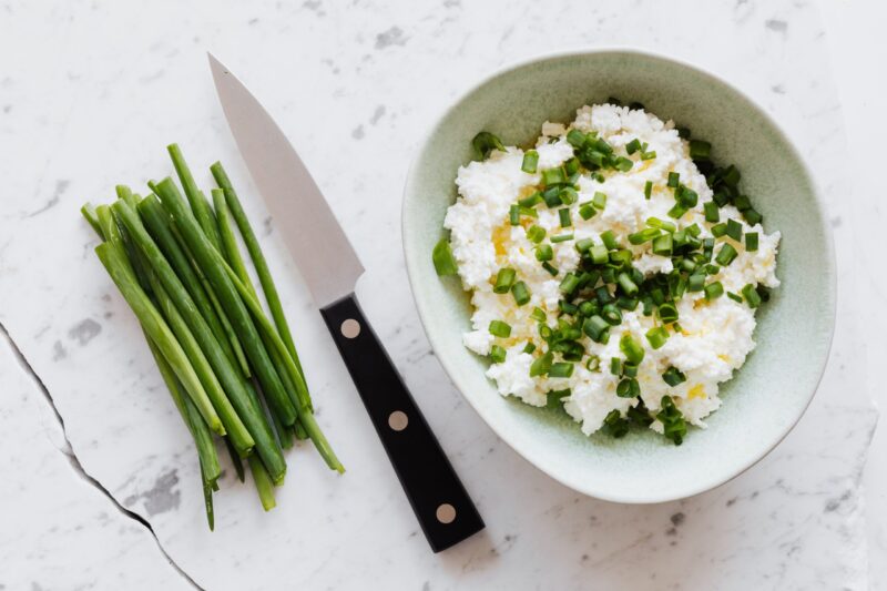 cottage cheese in bowl with chopped chives