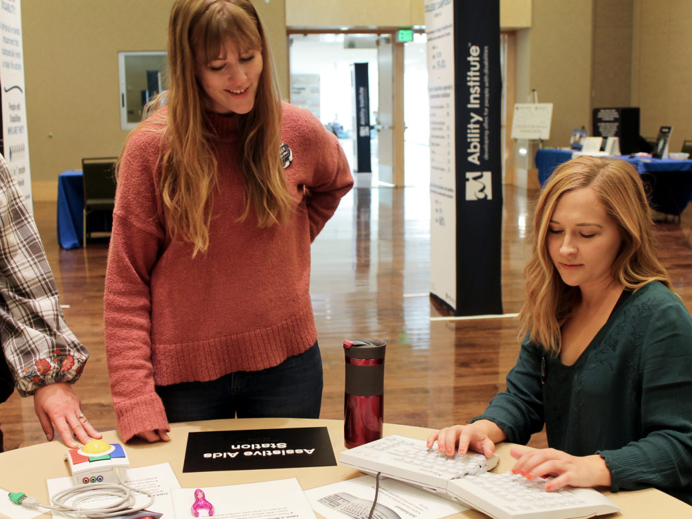 Two occupational therapy students using an alternative keyboard