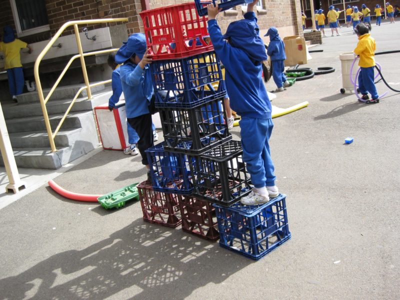 children stacking milk crates