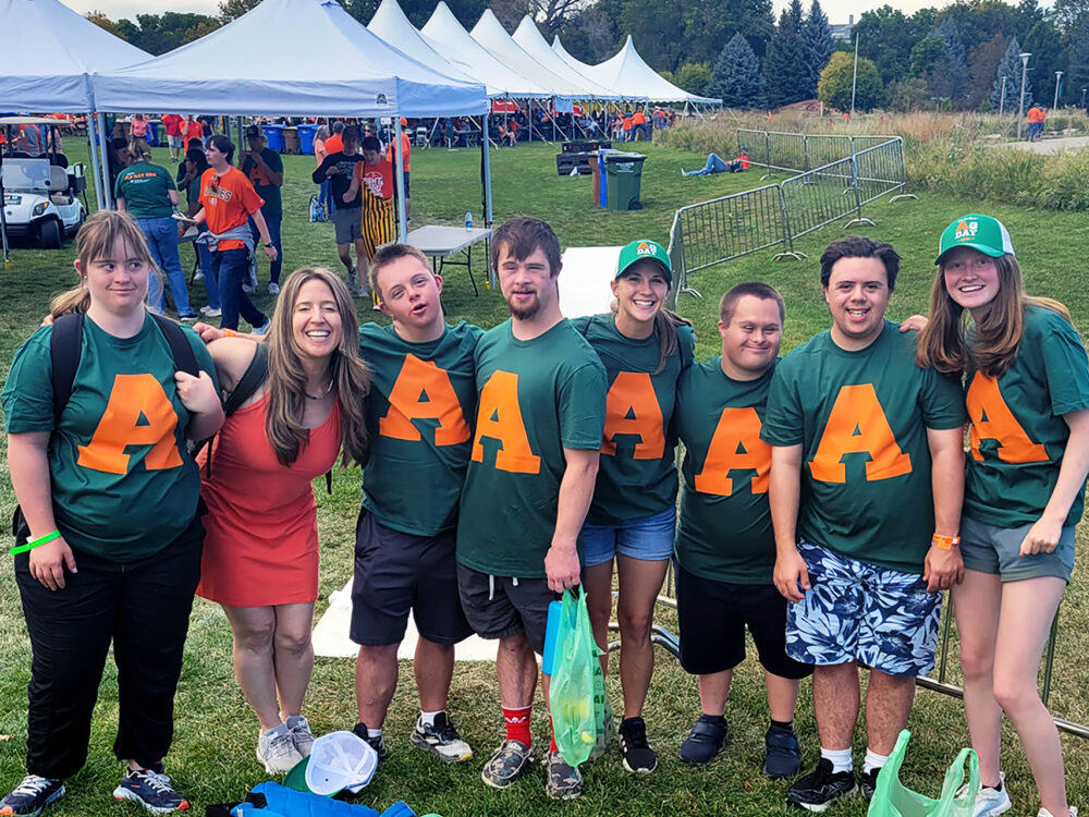 RAM Scholar participants posing for a photo while all wearing their green Ag Day shirts with a large orange `A` on it