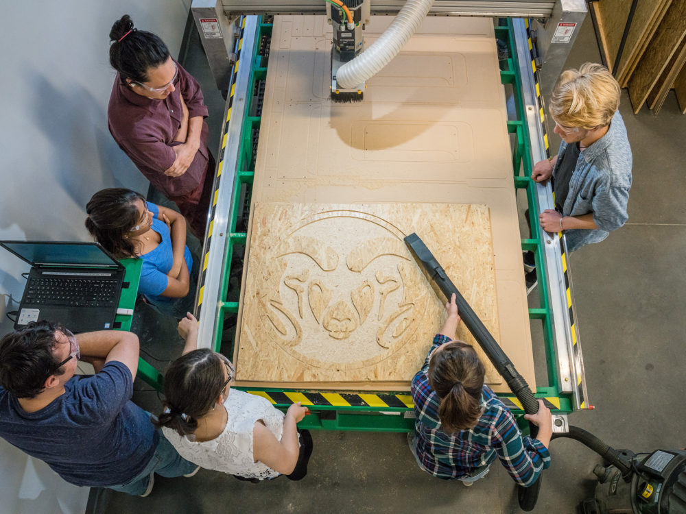 Students using the wood laser cutting machine