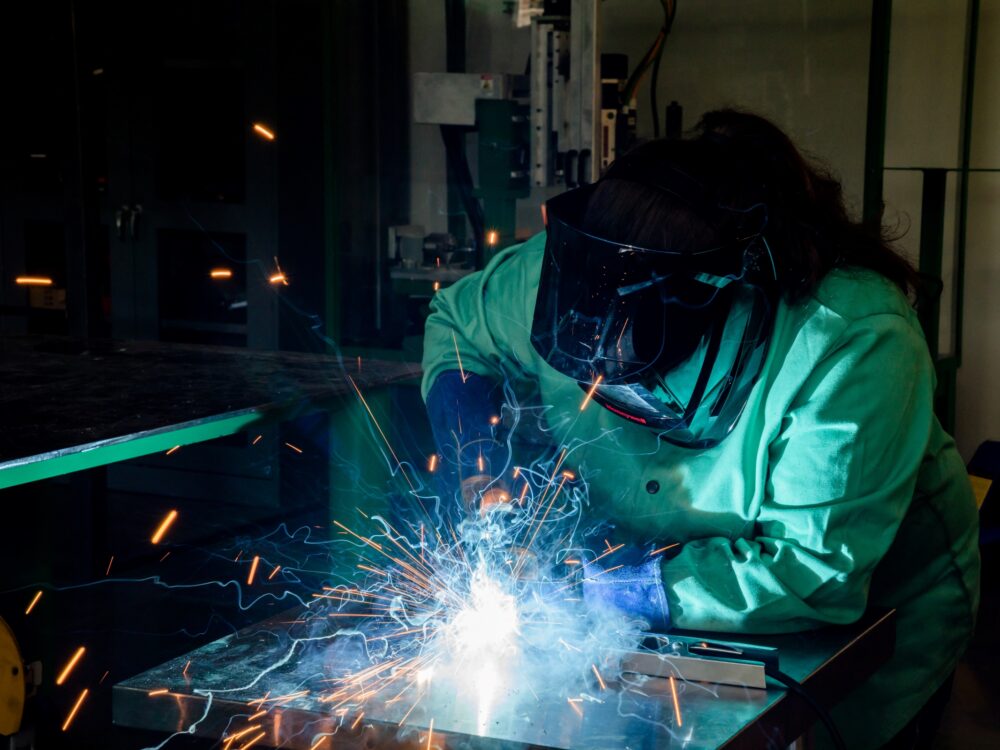 A student using the MIG welder in the Metal Lab