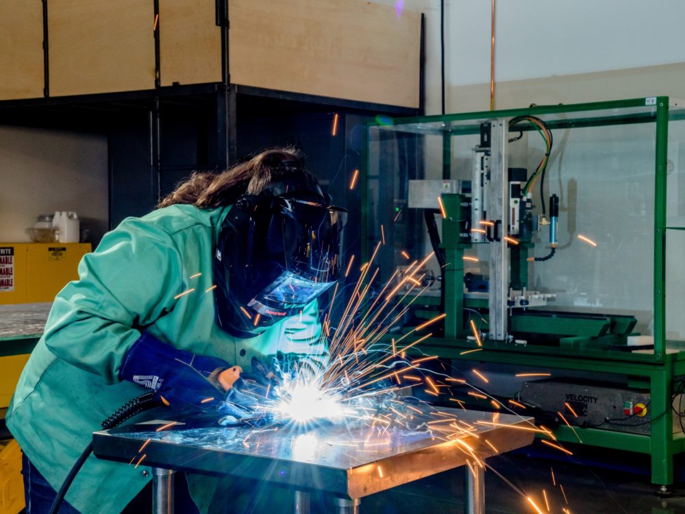 A student using a MIG welder in the Metals Lab
