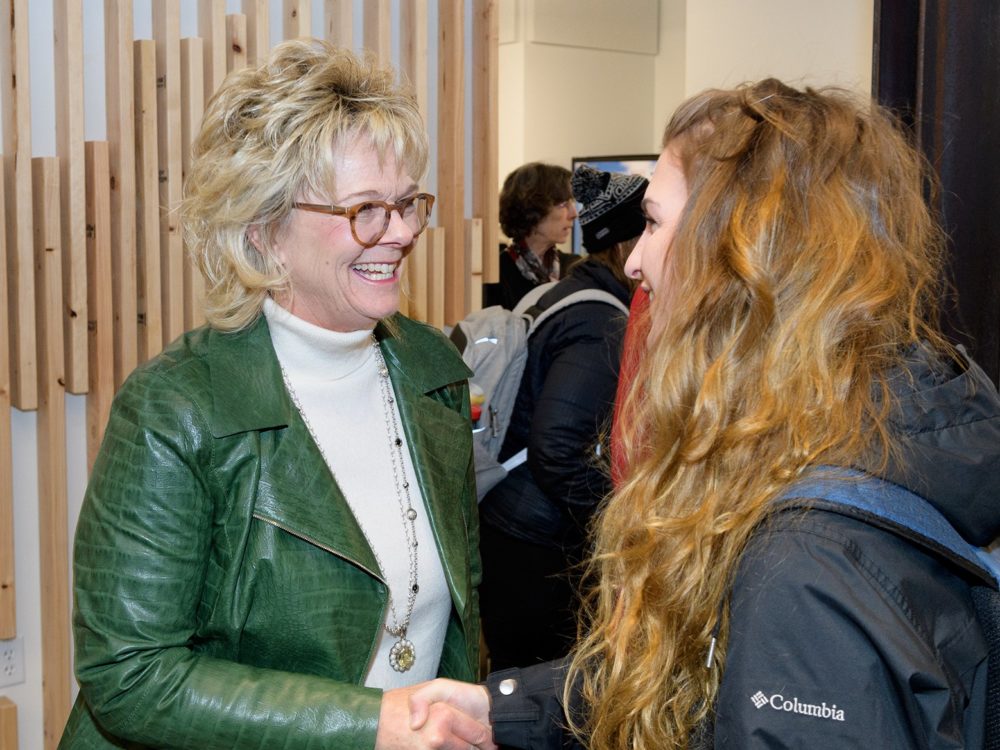 Nancy Richardson greeting a student at an event