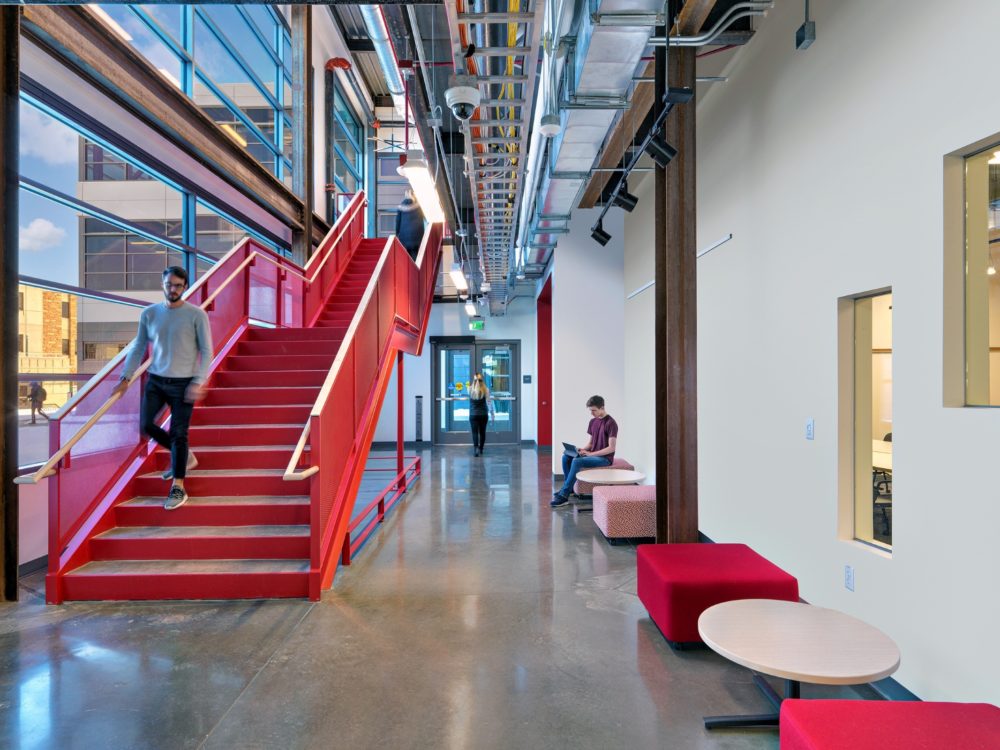 Image of a hallway with a red stairwell called Maker's Way in the Nancy Richardson Design Center
