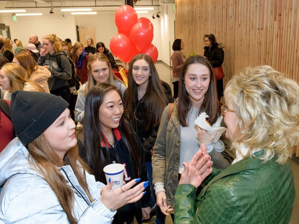 Nancy Richardson greets students at an event in the Design Exchange