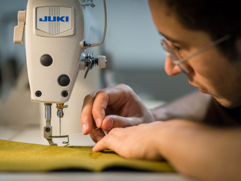 A student uses a sewing machine in the Prototype Lab
