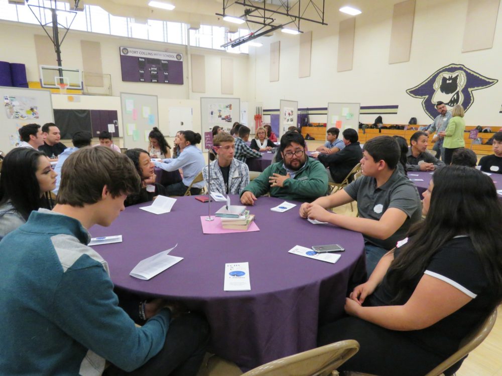 Caminos students talk to community representative at Caminos FCHS luncheon