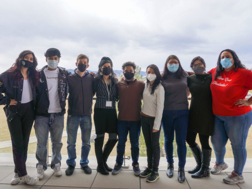 Caminos students in a group with Antonette Aragon wearing masks