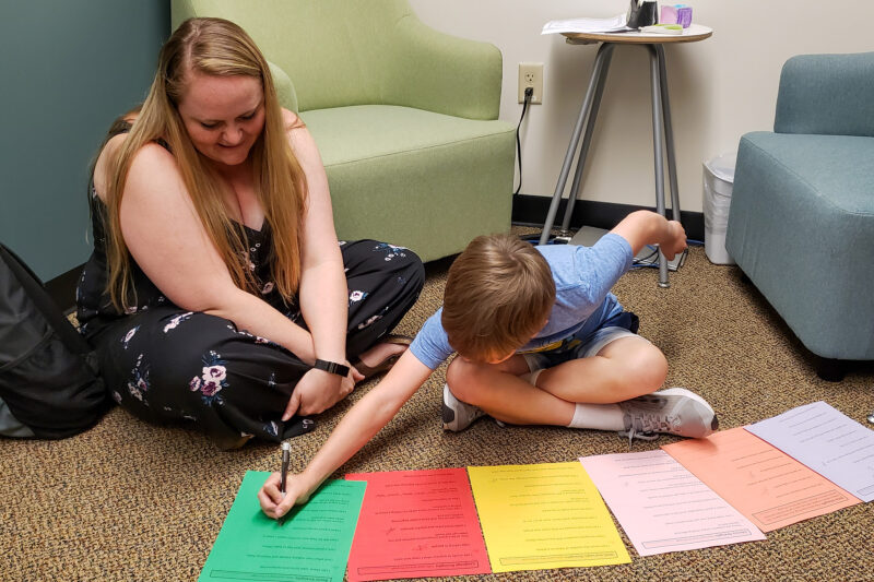 counseling student works with elementary student