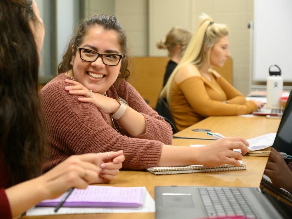 Student smiling in a class