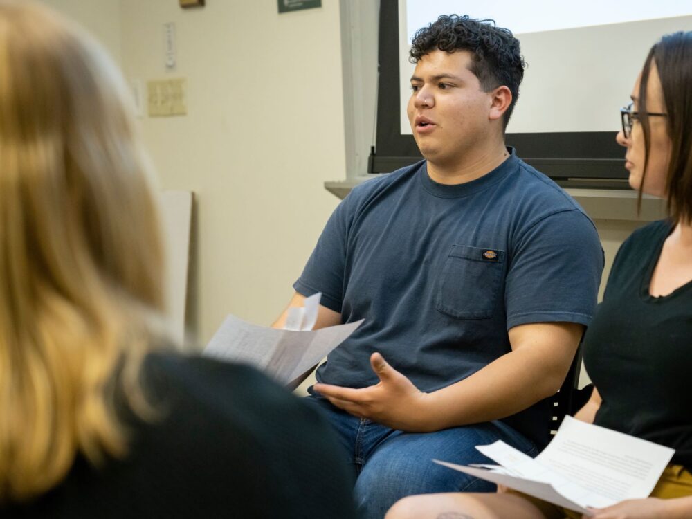 A student speaking during a group activity.