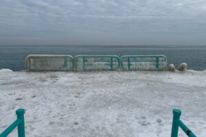 An icy dock looking outward to Lake Michigan.