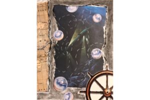 An abstract, mixed-media collage featuring various objects.