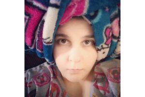 A self-portrait of a Through the Lens contributor with a blanket wrapped around the top of their head.