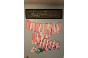 A wall with a picture that reads "The best things in life are the people. We love the places we've been and the memories we've made along the way" and multiple handwritten notes of encouragement.